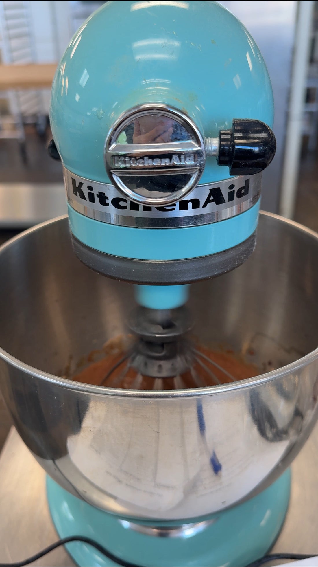 blue kitchen aid mixer mixing batter