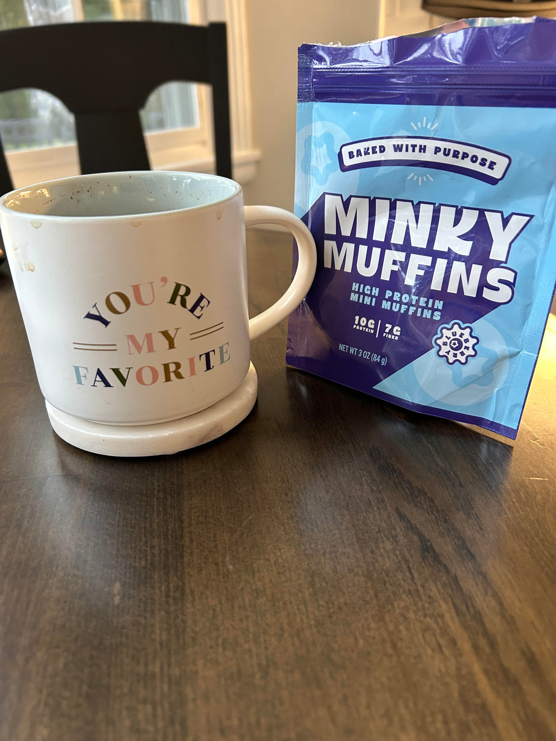 a coffee mug that says "you're my favorite" next to an open bag of Minky Muffins